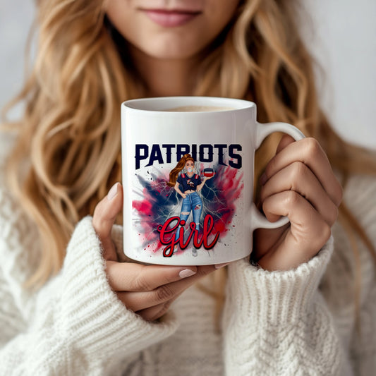 A woman in a white sweater holds the Patriots Girl Ceramic Mug | 11oz by Kreative Kreationz, featuring a sublimated design of a woman in jeans and a Patriots shirt on a red, white, and blue splatter background.
