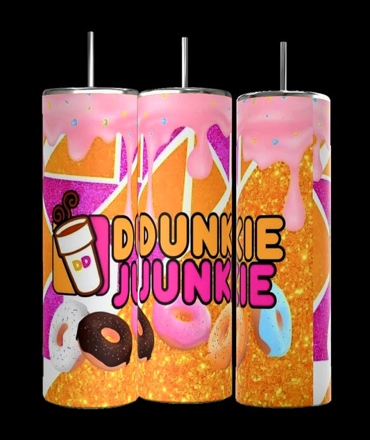 These Dunkin Junkie Drip 20oz Tumblers by Kreative Kreationz are vibrantly handmade and adorned with donut images and dripping pink frosting. The phrase "DUNKIN JUNKIE DRIP," accompanied by a small coffee cup icon on the left, is boldly printed on the front. They feature a glittery gold background.