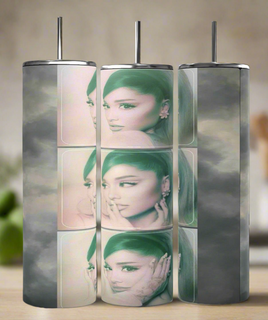 The Ariana Grande Aesthetic 20oz skinny tumblers by Kreative Kreationz feature a cylindrical design with faded images of her iconic hairstyle and signature pose, set against a gray cloud-like background for artistic flair.