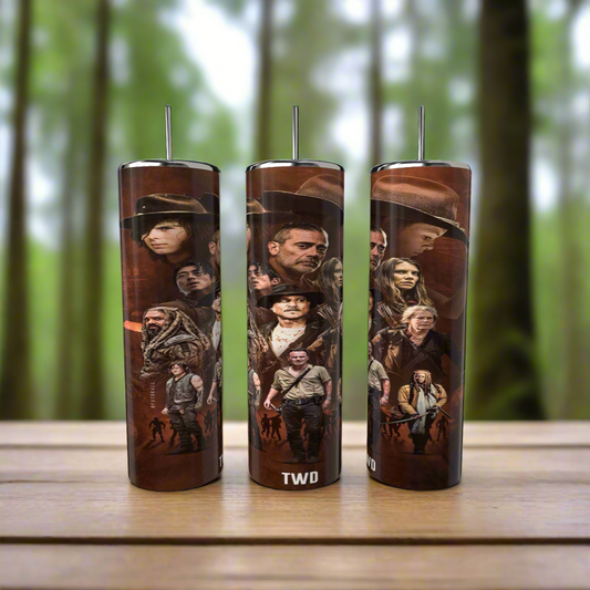 Three Kreative Kreationz Walking Dead 20oz Skinny Tumblers with spill-proof lids and reusable straws rest on a wooden surface. Each features iconic characters from the show against a blurred forest backdrop for added convenience and style.