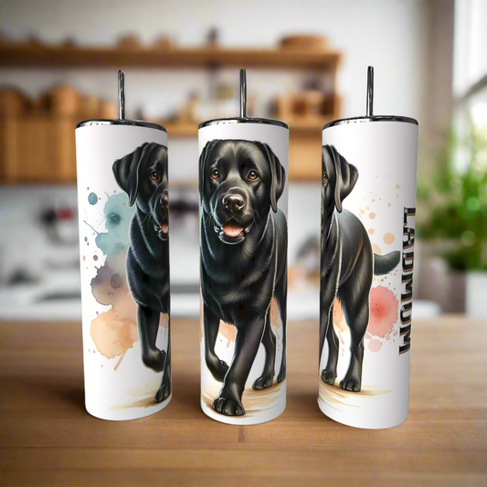 Three Kreative Kreationz Lab Dog Mom 20oz Tumblers with metal straws rest on wood, each featuring a realistic black Lab and artistic paint splatters—eco-friendly drinkware ideal for any Lab Dog Mom. A blurred kitchen is in the background.