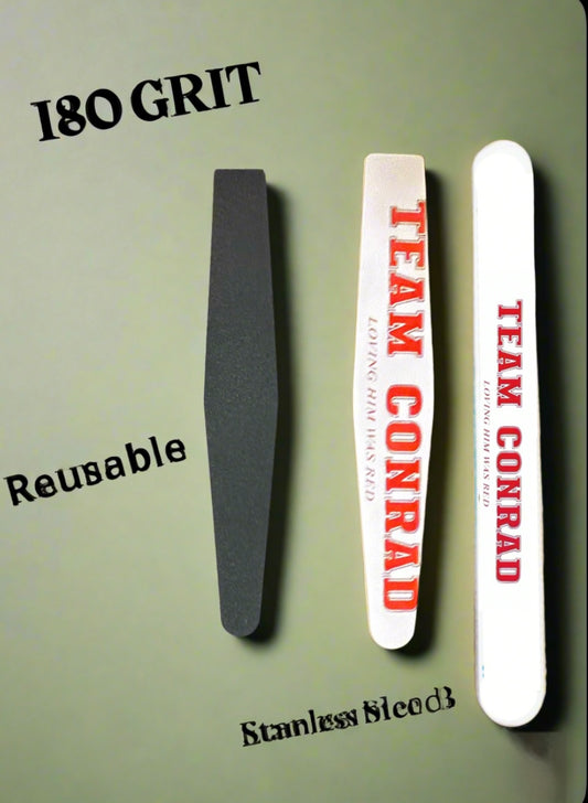 Three Kreative Kreationz Team Conrad Ceramic Nail Files stand vertically on a gray background. The left file is labeled "180 GRIT," while the two white files with red text read "TEAM CONRAD." They feature reusable and stainless block labels.