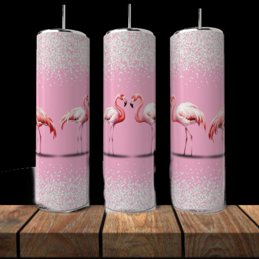 Three Kreative Kreationz Pink Flamingo 20oz Tumblers with silver lids and straws display illustrated flamingos and white glitter accents, arranged on wood with a black background.
