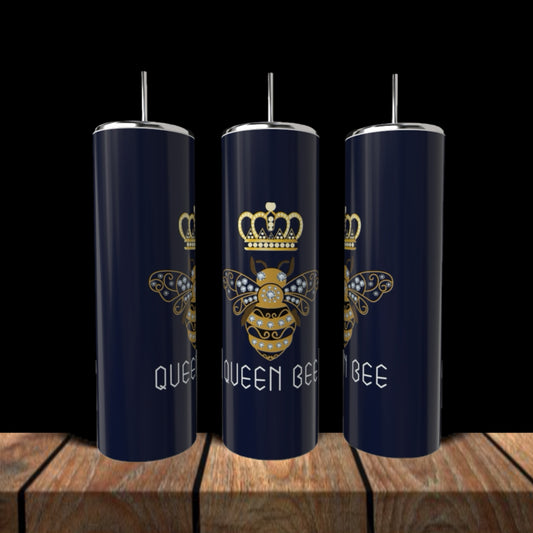 Three Kreative Kreationz Queen Bees 20oz Tumblers with silver lids and straws sit on a wooden surface, each featuring a gold crowned bee and the words “QUEEN BEE” in white on navy blue stainless steel.