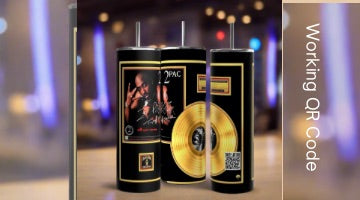 Three Kreative Kreationz 2Pac 20oz tumblers, featuring gold record designs, a rapper’s photo, and a working QR code playlist, stand upright. The blurred background has blue and yellow lights. “Working QR Code” is displayed on the right.
