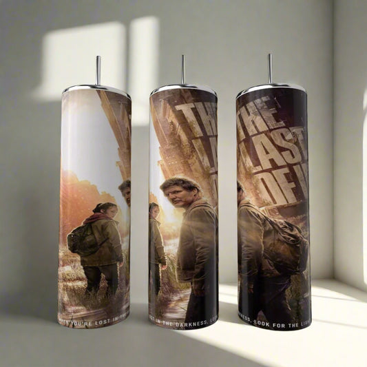 The Last Of Us Tumbler by Kreative Kreationz showcases two characters in outdoor gear amid a post-apocalyptic scene, with the TV series title boldly displayed. Set includes three stainless steel tumblers.