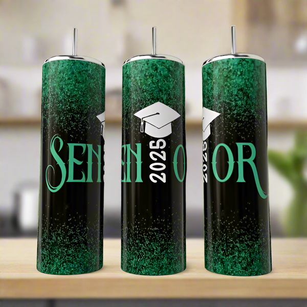 Three Kreative Kreationz 2025 Senior Graduate 20oz tumblers in green and black with a glittery luxury design, "SENIOR" text, a white graduation cap, and "2025" printed vertically are displayed on a wooden surface.