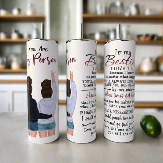 Displayed are three "Your My Person | Best Friend 20oz Tumbler" from Kreative Kreationz, each customizable with lids and straws, featuring illustrations of two women with arms raised and heartfelt friendship messages, celebrating cherished connections against a blurred kitchen setting.
