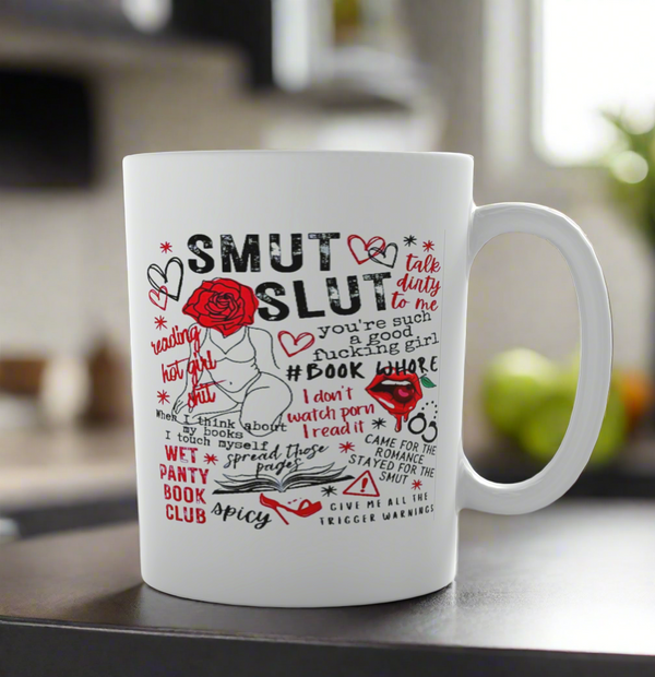 The Smut Ceramic Mug by Kreative Kreationz features bold text, hearts, roses, and flirty romance phrases—perfect for spicy book lovers. Conveniently dishwasher safe, it adds playful charm to your kitchen counter.