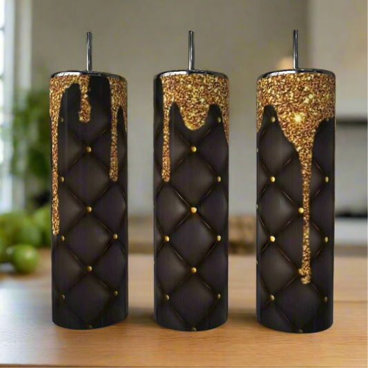 Three Gold Drip Textured 20oz Skinny Tumblers by Kreative Kreationz, featuring a quilted black and gold design with gold glitter drips, are displayed on a wooden surface, bringing luxury to reusable drinkware.