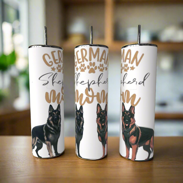 Three Kreative Kreationz German Shepherd Mom 20oz Tumblers with adorable dog designs rest on a kitchen surface, each crafted from eco-friendly stainless steel for a stylish and practical touch.
