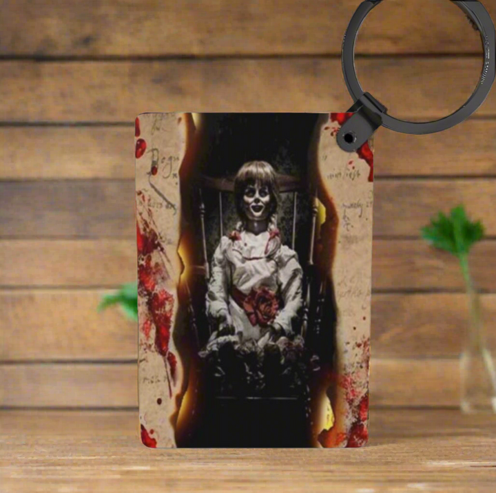 Phone case with horror-themed design featuring a doll on a wooden surface