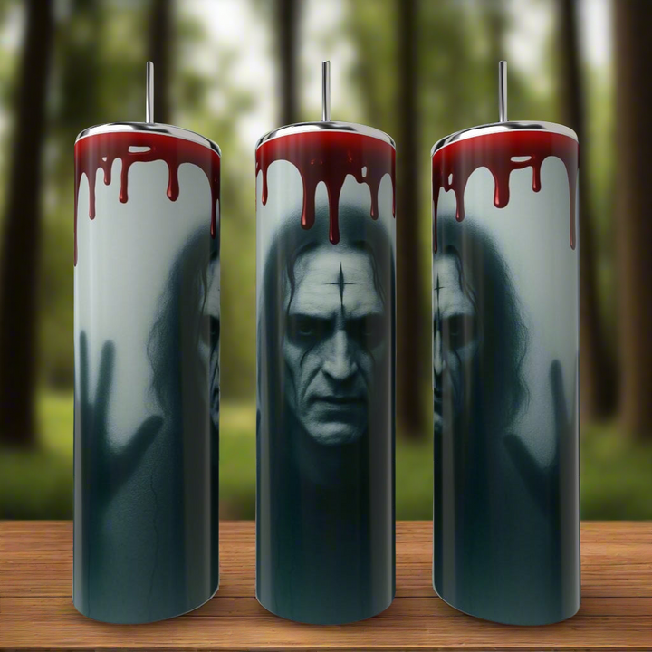 Kreative Kreationz’s The Crow 20oz Tumblers showcase a haunting pale man with hollow eyes and blood-like red liquid dripping, set against a blurred forest, on durable stainless steel drinkware.