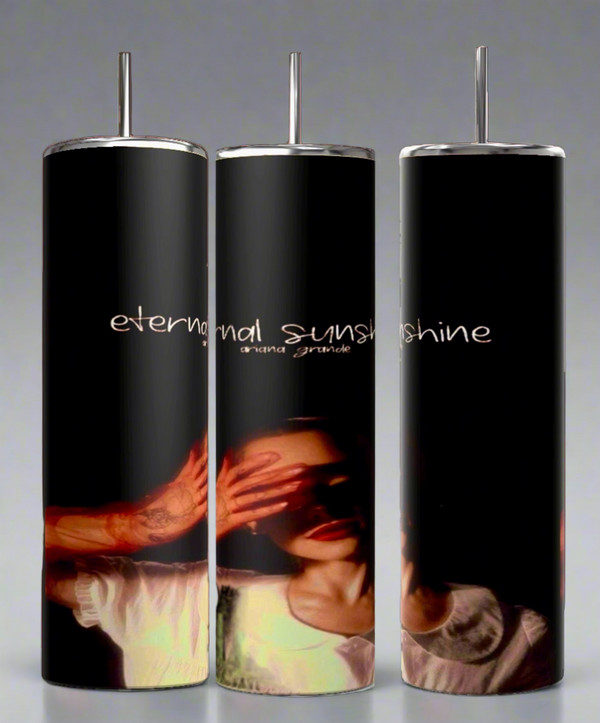 The set of three External Sunshine 20oz Tumblers by Kreative Kreationz showcases a dark, moody design with an image of a person partially covering their face. "Eternal sunshine" and "grana grande" are inscribed above. They feature durable construction and spill-proof lids for convenience.
