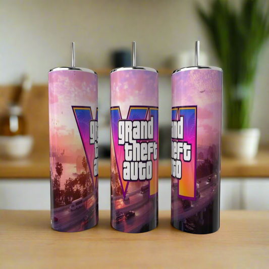 Three eco-friendly Kreative Kreationz Grand Theft Auto 20oz Tumblers featuring palm trees, cars, and a sunset design are displayed on a wooden kitchen surface.