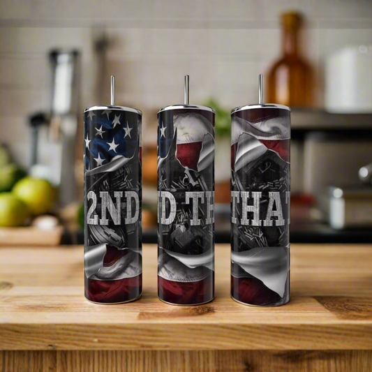 Three Kreative Kreationz 2nd Amendment 20oz Skinny Tumblers with straws sit on a kitchen counter. Each stainless steel tumbler displays bold, distressed white “2ND AMEND THAT” lettering, adding contrast to the modern kitchen setting.