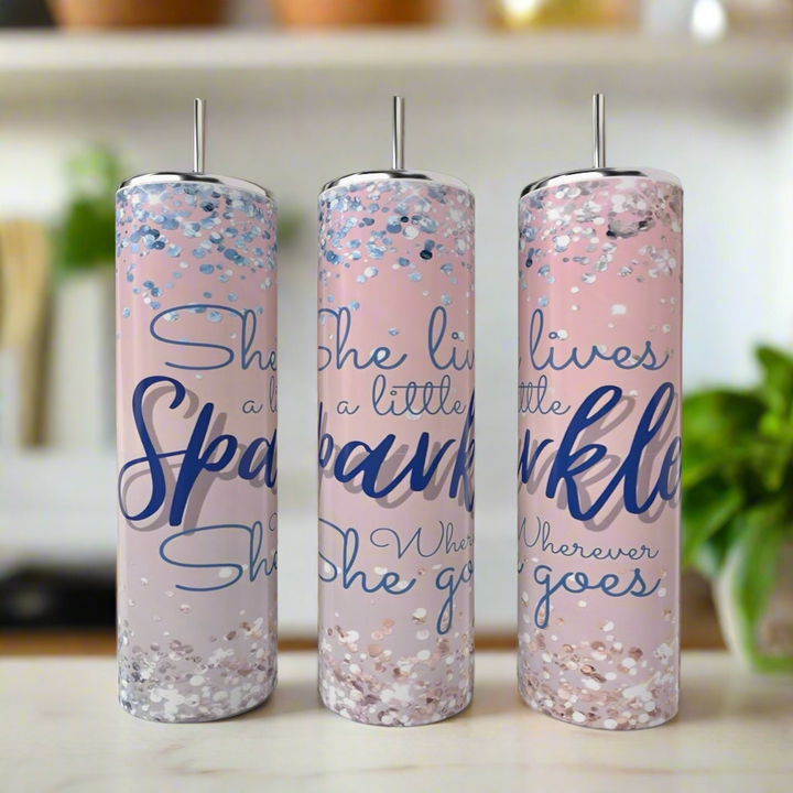 Three 20oz Kate Spade She Leaves Sparkle skinny tumblers by Kreative Kreationz, featuring pink design, silver lids and straws, blue and silver glitter accents, and the quote "She leaves a little sparkle wherever she goes.