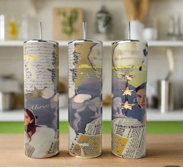 Three tall Gracie Abrams 20oz Skinny Tumblers by Kreative Kreationz, featuring blue collage-style designs with butterflies, handwritten notes, a woman’s face, gold stars, and inspirational text, stand on a kitchen counter.