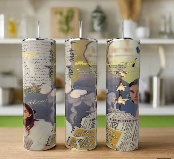 Three tall Gracie Abrams 20oz Skinny Tumblers by Kreative Kreationz, featuring blue collage-style designs with butterflies, handwritten notes, a woman’s face, gold stars, and inspirational text, stand on a kitchen counter.