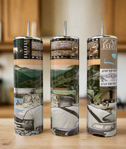 Three eco-friendly Kreative Kreationz Zach Bryan 20oz Tumblers with metal straws feature luxury-inspired designs: collage-style mountains, a man outdoors, song lyrics, and film strips—all set on a kitchen’s wooden table.