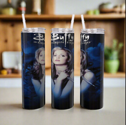 Three tall Buffy Travel Tumblers by Kreative Kreationz, each with a straw and luxury-inspired designs of a woman plus “Buffy The Vampire Slayer” text, are displayed on a kitchen countertop with blurred shelves in the background.