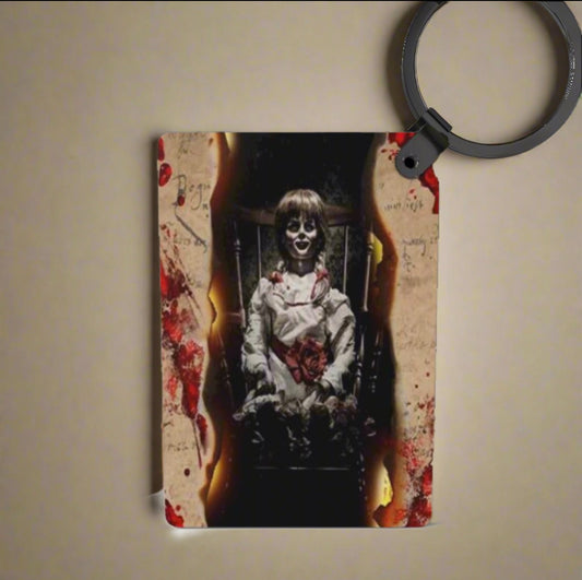 Keychain with a design of a ghostly figure and bloodstains on a beige background